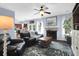 Comfortable living room featuring a fireplace, ceiling fan, and view into the kitchen at 1255 Horseshoe Bnd, Mount Pleasant, SC 29464