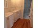 Bright bathroom with dual vanities, hardwood floors, and a glass shower at 136 Tall Pines Rd, Ladson, SC 29456