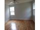 Bright bedroom featuring hardwood floors, a ceiling fan, and two windows allowing ample natural light at 136 Tall Pines Rd, Ladson, SC 29456