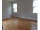 Spacious room with hardwood floors and plenty of light from two windows at 136 Tall Pines Rd, Ladson, SC 29456