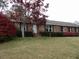 Charming brick home with a well-maintained lawn and blossoming azalea bushes at 136 Tall Pines Rd, Ladson, SC 29456