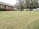 Large front lawn with mature trees and flowering shrubs enhancing the home's curb appeal at 136 Tall Pines Rd, Ladson, SC 29456