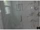Close-up of new glass shower with marble-look tiles and brushed-nickel hardware at 136 Tall Pines Rd, Ladson, SC 29456