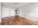 Open bedroom area with hardwood floors, ceiling fan, and utility closet access at 14 Lockwood Dr # 6E, Charleston, SC 29401
