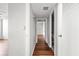 Bright hallway featuring wood flooring, clean white walls, and access to bathroom and bedroom at 14 Lockwood Dr # 6E, Charleston, SC 29401