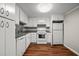 Cozy kitchen with white cabinets, laminate wood flooring and a granite pattern countertop at 14 Lockwood Dr # 6E, Charleston, SC 29401