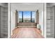 Empty room featuring hardwood floors, built-in shelving, and a lovely harbor view at 14 Lockwood Dr # 6E, Charleston, SC 29401