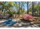 Spacious backyard with a patio, seating, and flowering azalea bushes at 1411 River Front Dr, Charleston, SC 29407