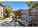 Cozy backyard patio with a wooden bench, colorful plants, and a wood privacy fence at 1411 River Front Dr, Charleston, SC 29407