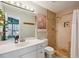 Well-lit bathroom featuring tile shower, stylish vanity, and modern fixtures at 1411 River Front Dr, Charleston, SC 29407
