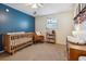 Cozy Bedroom with crib, changing table, rocking chair, and ample natural light at 1411 River Front Dr, Charleston, SC 29407