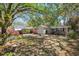 Lovely single-story home with a well-manicured lawn, mature trees, and flowering bushes at 1411 River Front Dr, Charleston, SC 29407