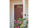 Close up of the front door with a storm door, windows, and a view of flower bushes at 1411 River Front Dr, Charleston, SC 29407