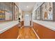 Inviting hallway with hardwood floors, wainscoting, artwork, and a view of the front door at 1411 River Front Dr, Charleston, SC 29407