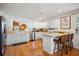 Bright kitchen featuring white cabinets, stainless steel appliances, breakfast bar, and hardwood floors at 1411 River Front Dr, Charleston, SC 29407