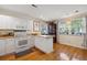 Cozy kitchen with white cabinetry, breakfast bar, and a light-filled dining area at 1411 River Front Dr, Charleston, SC 29407