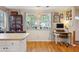Eat-in kitchen featuring hardwood floors, a breakfast bar, and a charming home office nook at 1411 River Front Dr, Charleston, SC 29407