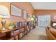 Inviting living room featuring a filled bookcase, carpet and white double doors at 1411 River Front Dr, Charleston, SC 29407