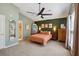 Spacious main bedroom with large window, ceiling fan, carpet, ensuite and closet at 1411 River Front Dr, Charleston, SC 29407