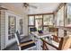 Cozy screened-in porch with tiled floors, ceiling fan and outdoor seating at 1411 River Front Dr, Charleston, SC 29407