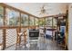 Enjoy this lovely screened-in porch with ceiling fan, furniture, and sun at 1411 River Front Dr, Charleston, SC 29407
