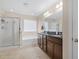Well-lit bathroom featuring a double vanity, bathtub, glass shower, and tile flooring at 143 Basket Grass Ln, Summerville, SC 29486