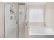 Bright bathroom featuring a glass shower, soaking tub, and window for natural light at 143 Basket Grass Ln, Summerville, SC 29486