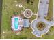 Aerial view of a community pool with ample seating and well-manicured landscaping with parking nearby at 143 Basket Grass Ln, Summerville, SC 29486