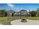 Cozy fire pit and wooden swing set in a shared community space with greenery at 143 Basket Grass Ln, Summerville, SC 29486