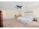 Spacious main bedroom with a ceiling fan, neutral paint, carpet flooring, and ample natural light at 143 Basket Grass Ln, Summerville, SC 29486