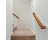 Carpeted stairway with wooden handrail offers a safe and stylish transition between floors at 143 Basket Grass Ln, Summerville, SC 29486