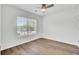 Bedroom with hard wood floors, white trim, ceiling fan, and a view from the window at 150 Sugar Magnolia Way, Charleston, SC 29414