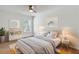 Bedroom featuring a decorated bed, neutral decor, ceiling fan, and window views at 150 Sugar Magnolia Way, Charleston, SC 29414