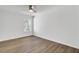 Bright bedroom features a window, ceiling fan, and wood-look floors at 150 Sugar Magnolia Way, Charleston, SC 29414