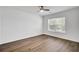 Bedroom with hardwood floors, ceiling fan, and a large window at 150 Sugar Magnolia Way, Charleston, SC 29414
