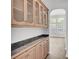 Open dining area with built-in cabinets and marble countertops, leading to a bright living area at 150 Sugar Magnolia Way, Charleston, SC 29414