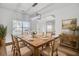 Elegantly staged dining room with a wooden table set for a meal, decorative lighting, and a bright, inviting atmosphere at 150 Sugar Magnolia Way, Charleston, SC 29414