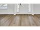 Bright entryway featuring hardwood floors and a white door, providing a clean and open transition into the home's interior spaces at 150 Sugar Magnolia Way, Charleston, SC 29414