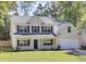 Charming two-story home featuring a welcoming front porch, well-maintained lawn, and attached garage, offering classic curb appeal at 150 Sugar Magnolia Way, Charleston, SC 29414