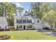 Inviting two-story home with a manicured front yard and an American flag, showcasing a blend of comfort and patriotic pride at 150 Sugar Magnolia Way, Charleston, SC 29414