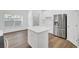 Bright kitchen featuring stainless steel appliances and a white kitchen island at 150 Sugar Magnolia Way, Charleston, SC 29414