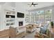 Inviting living room with fireplace, built-in shelving, and large windows for natural light at 150 Sugar Magnolia Way, Charleston, SC 29414