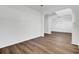 Spacious living room with hardwood floors, white walls, and arched doorways, creating an open and inviting area for relaxation at 150 Sugar Magnolia Way, Charleston, SC 29414
