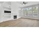 Bright living room with fireplace, built-in shelving, and large windows at 150 Sugar Magnolia Way, Charleston, SC 29414