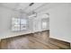 Bright living room with modern light fixture, wood floors, and large windows at 150 Sugar Magnolia Way, Charleston, SC 29414