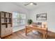 Inviting home office with a wooden desk, ample natural light from the window, and stylish decor, creating a productive workspace at 150 Sugar Magnolia Way, Charleston, SC 29414