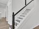 Staircase featuring dark wood stairs, white risers, and a classic white spindle and dark wood handrail at 150 Sugar Magnolia Way, Charleston, SC 29414