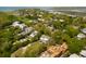 Aerial view showcasing neighborhood, pool, and lush greenery, near the ocean and marsh at 1651 Atlantic Ave, Sullivans Island, SC 29482