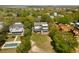 Stunning aerial view of lush neighborhood, homes with pools, and construction site with raw materials on the lot at 1651 Atlantic Ave, Sullivans Island, SC 29482