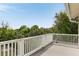 Balcony offers a private, tree-lined view, perfect for relaxing outdoors at 1651 Atlantic Ave, Sullivans Island, SC 29482